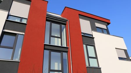 A residential home with a modern facade being painted in Suffolk, NY.