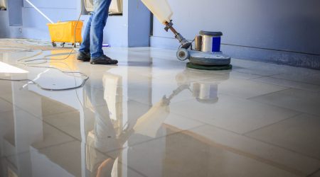 The people are cleaning the floor with a machine in Suffolk, NY.